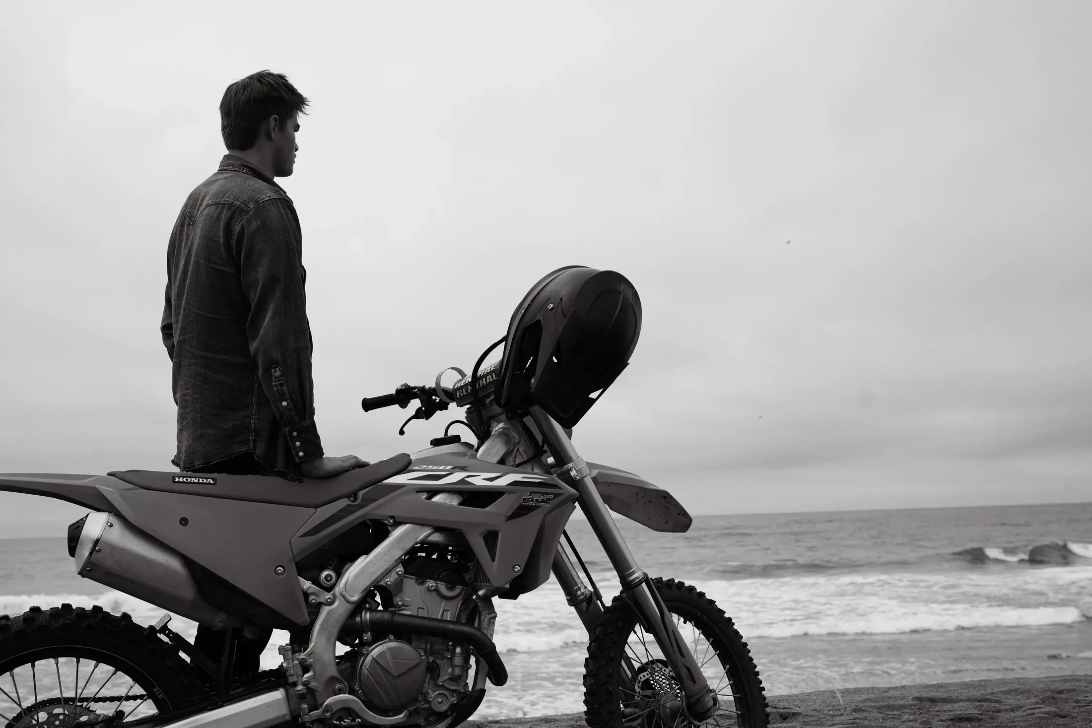 Luke Powell beside a dirt bike on the Northern California coast